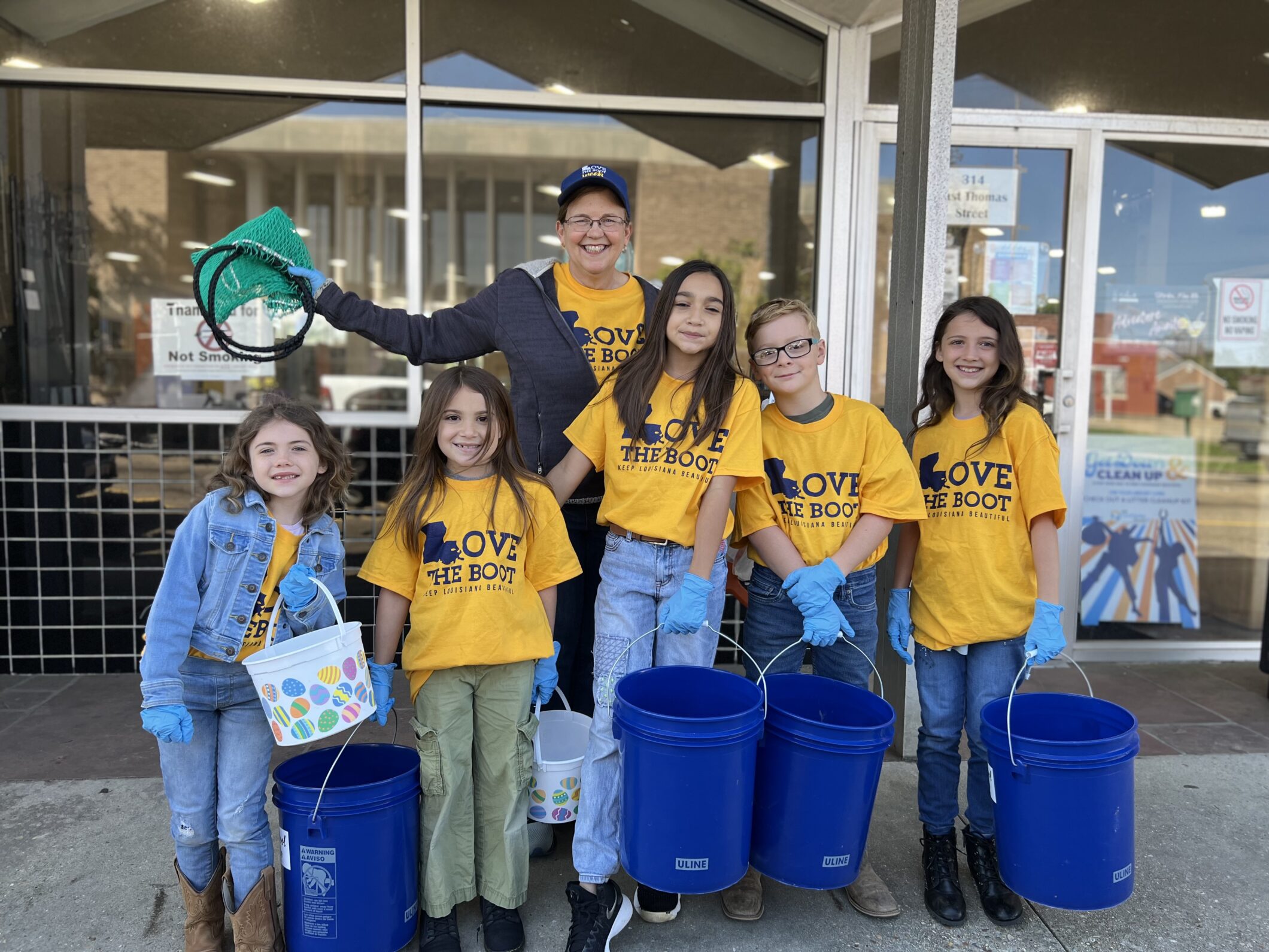 Kids with buckets cleaning up litter