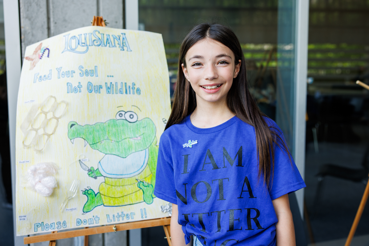Students with a poster promoting litter prevention