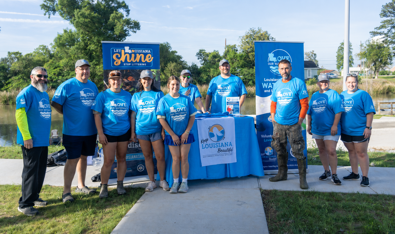 People posing at waterway cleanup