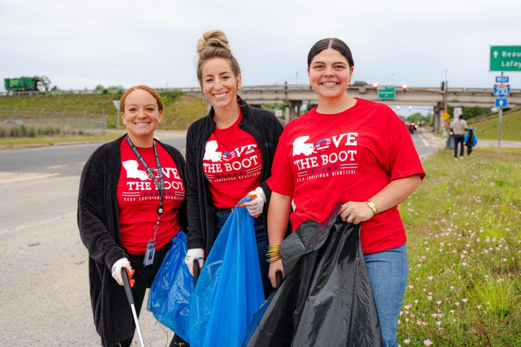 Three women volunteering to pick up litter