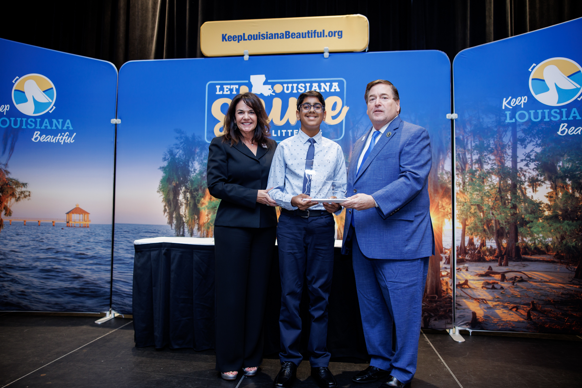 Student receiving an award on stage for environmental leadership