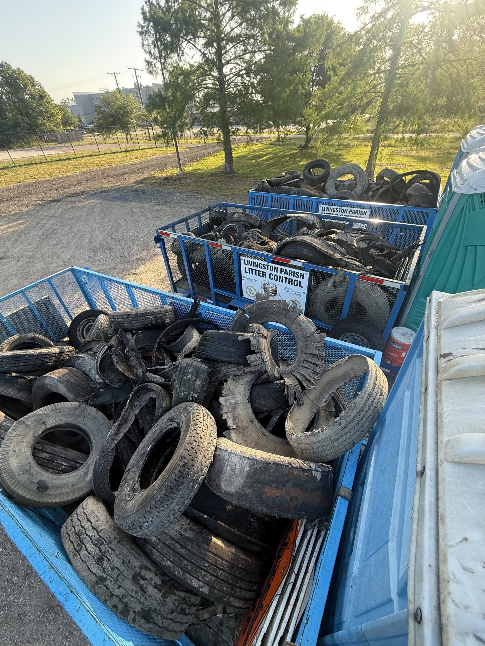 Multiple trailers filled with discarded tires collected by Livingston Parish and the Livingston Parish Sheriff’s Office during a Love the Boot Week cleanup event. The trailers are parked outdoors with signs identifying the Livingston Parish Litter Control program.